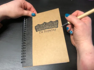 Garvin Clementsusing notebook and pen setOrder- 881980556